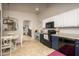 Open kitchen with white cabinets, dark lower cabinets, and modern appliances, connected to dining and living at 3098 E Stottler Dr, Gilbert, AZ 85296