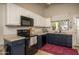Well-lit kitchen with white cabinets, dark lower cabinets, and modern appliances for cooking enjoyment at 3098 E Stottler Dr, Gilbert, AZ 85296