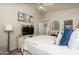 Bright main bedroom featuring a ceiling fan, accent pillows, and adjacent ensuite bathroom at 3098 E Stottler Dr, Gilbert, AZ 85296