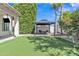 Relax in this backyard featuring a putting green, a shaded gazebo and mature landscaping at 3139 E Runaway Bay Pl, Chandler, AZ 85249