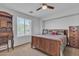Comfortable bedroom with a ceiling fan, a window view, and a wooden bed frame at 3139 E Runaway Bay Pl, Chandler, AZ 85249