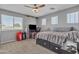 Bedroom with a ceiling fan, carpeted floors, and a window at 3139 E Runaway Bay Pl, Chandler, AZ 85249