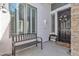 Cozy front porch with a bench, decorative door, and a textured wall finish at 3139 E Runaway Bay Pl, Chandler, AZ 85249