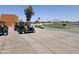 Golf carts parked near a well-manicured golf course with a serene pond and mountain views in the distance at 3139 E Runaway Bay Pl, Chandler, AZ 85249