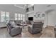 Spacious living room with a vaulted ceiling, a fireplace, and comfortable leather seating at 3139 E Runaway Bay Pl, Chandler, AZ 85249