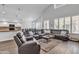 Open-concept living area with hardwood floors, vaulted ceiling, large sofa and lots of natural light at 3139 E Runaway Bay Pl, Chandler, AZ 85249