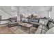 Cozy living space featuring a comfortable leather sofa and a view into the kitchen area at 3139 E Runaway Bay Pl, Chandler, AZ 85249