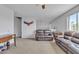 Spacious living room with carpeting, leather couches, and a ceiling fan at 3139 E Runaway Bay Pl, Chandler, AZ 85249