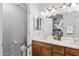Bright bathroom featuring a double sink vanity with wood cabinets and a large mirror at 3150 E Beardsley Rd # 1023, Phoenix, AZ 85050