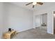 The bedroom featuring a ceiling fan, a mirrored closet, and neutral-toned carpet flooring at 3150 E Beardsley Rd # 1023, Phoenix, AZ 85050