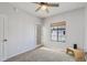 A cozy bedroom with a fan, closet, and plenty of natural light through the window at 3150 E Beardsley Rd # 1023, Phoenix, AZ 85050