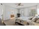Spacious bedroom features a ceiling fan, carpet flooring, and an ensuite bathroom at 3150 E Beardsley Rd # 1023, Phoenix, AZ 85050