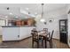 Dining area with adjacent kitchen features an open layout, ideal for modern living at 3150 E Beardsley Rd # 1023, Phoenix, AZ 85050