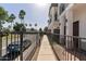 An exterior walkway showing the side of the building with wrought iron fencing at 3150 E Beardsley Rd # 1023, Phoenix, AZ 85050