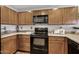 Kitchen features countertops, black appliances, and ample cabinet space at 3150 E Beardsley Rd # 1023, Phoenix, AZ 85050