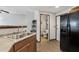 Kitchen with stainless steel sink, wood cabinets, and view to dining and living room at 3150 E Beardsley Rd # 1023, Phoenix, AZ 85050