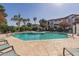 Community pool surrounded by lush landscaping and lounge chairs at 3150 E Beardsley Rd # 1023, Phoenix, AZ 85050