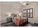 Bedroom featuring a ceiling fan, wood-look floors, and shuttered windows at 3301 S Goldfield Rd # 6050, Apache Junction, AZ 85119