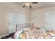 Bright bedroom featuring a ceiling fan and closet with slider doors at 3301 S Goldfield Rd # 6050, Apache Junction, AZ 85119