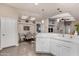 Open concept kitchen features stainless steel appliances, white cabinetry, and a breakfast bar connecting to dining room at 3301 S Goldfield Rd # 6050, Apache Junction, AZ 85119