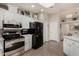Modern kitchen featuring stainless steel appliances, skylight, sleek white cabinets, and ample counter space at 3301 S Goldfield Rd # 6050, Apache Junction, AZ 85119