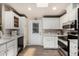 Modern kitchen featuring stainless steel appliances, white cabinetry, stone countertops and an exterior door to the outside at 3301 S Goldfield Rd # 6050, Apache Junction, AZ 85119