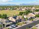 Scenic aerial view of a neighborhood with lush trees and blue mountains in the distance at 3574 E Latham Way, Gilbert, AZ 85297