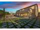 Expansive backyard featuring a pool, manicured lawn with geometric stone design, and covered patio for outdoor entertaining at 3574 E Latham Way, Gilbert, AZ 85297