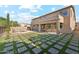 Expansive backyard with a pool, patio area, and unique grass/stone paver design, ideal for outdoor living and entertaining at 3574 E Latham Way, Gilbert, AZ 85297