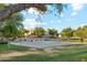 Community basketball court surrounded by lush landscaping, providing a great space for sports and recreation at 3574 E Latham Way, Gilbert, AZ 85297