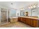 Luxury bathroom featuring dual sinks, a large soaking tub, and separate glass shower at 3574 E Latham Way, Gilbert, AZ 85297