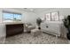 Cozy Bedroom featuring a crib, comfortable chair with ottoman, and stylish decor, creating a serene space at 3574 E Latham Way, Gilbert, AZ 85297
