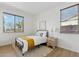 Cozy bedroom with a metal bed frame, and a neutral color palette, and a large window at 3574 E Latham Way, Gilbert, AZ 85297