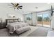 Serene bedroom featuring a king-size bed, ceiling fan, and balcony access at 3574 E Latham Way, Gilbert, AZ 85297