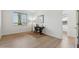 Bright bedroom with wood floors, desk, and large window providing natural light at 3574 E Latham Way, Gilbert, AZ 85297