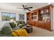 Bonus room with built in shelving with sofa, ceiling fan, and natural light at 3574 E Latham Way, Gilbert, AZ 85297