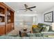 Cozy bonus room with ceiling fan, built-in shelves, and a comfortable green sofa at 3574 E Latham Way, Gilbert, AZ 85297