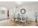 Open dining room with mirrored dining set, decorative mirror, neutral walls, and stone-look tile at 3574 E Latham Way, Gilbert, AZ 85297