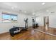 Home gym featuring wood floors, a full-length mirror, and an elliptical machine at 3574 E Latham Way, Gilbert, AZ 85297