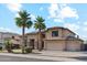 Beautiful two-story home featuring a spacious three-car garage and lush landscaping, under a sunny, partly cloudy sky at 3574 E Latham Way, Gilbert, AZ 85297