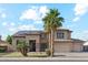 Stunning two-story home featuring a spacious three-car garage, lush landscaping, and a welcoming front entrance at 3574 E Latham Way, Gilbert, AZ 85297