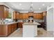 Traditional kitchen with wood cabinetry, tile countertops, and breakfast bar seating at 3574 E Latham Way, Gilbert, AZ 85297