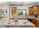 Kitchen island with eat-in bar and seating, wooden cabinetry, and stainless steel appliances at 3574 E Latham Way, Gilbert, AZ 85297
