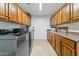 Efficient laundry room featuring ample storage and modern appliances at 3574 E Latham Way, Gilbert, AZ 85297
