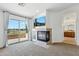Cozy living room featuring a fireplace, balcony access, and a mounted television at 3574 E Latham Way, Gilbert, AZ 85297