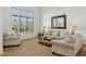 Bright living room featuring neutral furniture, large windows with shutters, and a decorative mirror at 3574 E Latham Way, Gilbert, AZ 85297