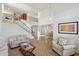 Open-concept living room with staircase, white walls, wood floors, and a view to the dining area at 3574 E Latham Way, Gilbert, AZ 85297