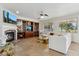 A spacious living room features a fireplace, media center, and ample seating with large windows at 3574 E Latham Way, Gilbert, AZ 85297