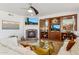 A bright living room features a fireplace, entertainment center, and neutral furniture at 3574 E Latham Way, Gilbert, AZ 85297