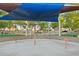 Community splash pad with various interactive water features under a shaded canopy for fun and safe water play at 3574 E Latham Way, Gilbert, AZ 85297